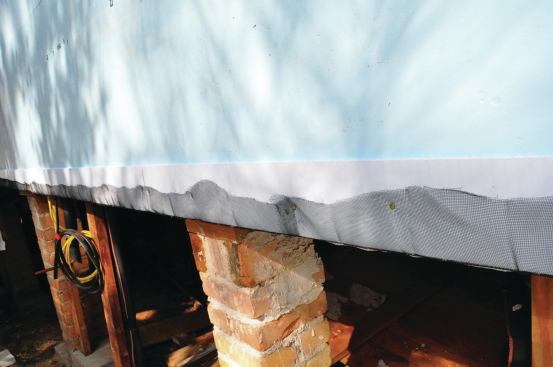 Before the top and bottom strips are installed, an 8-inch-wide strip of insect screen is stapled on and folded back over the Coroplast to keep out the bugs.