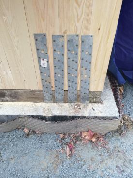 The sill plate dimensions needed to be spot on, as panels can’t be altered much. Metal hold-down straps anchored the panel to the plate.