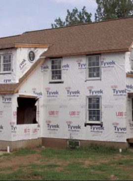 While foam is water resistant and provides a good barrier against the bulk of the weather, wind-driven rain can find its way around panels and through joints, so Caulkins relies on a housewrap and careful window flashing installed over a fully sheathed structure before installing the foam.