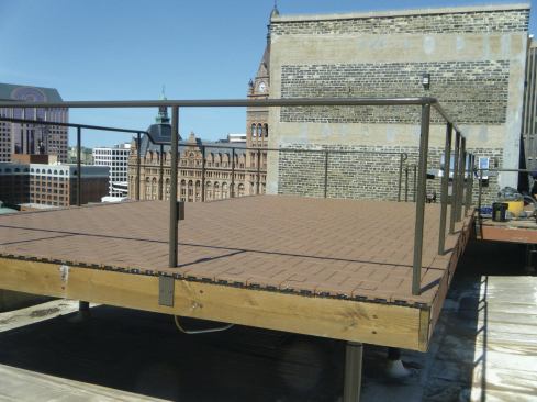 Faced with the logistics of transporting traditional decking in a freight elevator up to the roof of this downtown high-rise building, the author chose instead to resurface the deck with composite pavers. 
