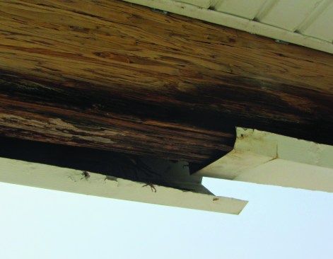 Aluminum capping had been applied over the beams, creating a trough and holding water that leaked in from above.