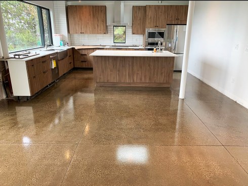 If a house is built on a structural slab, consider finishing the slab surface to avoid introducing yet more materials into the home. (Photo courtesy Hard Rock Concrete Coatings)
