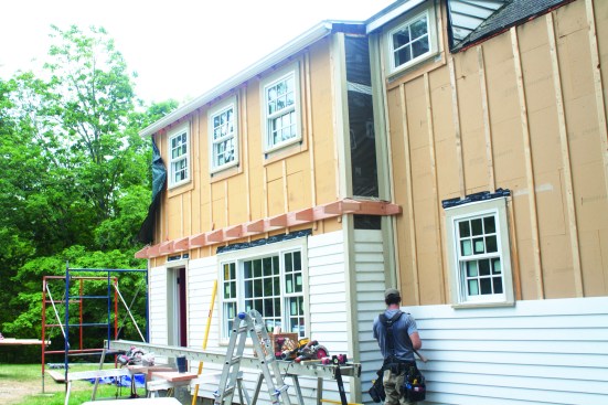 Then they fastened on a new, tapered roof-and-soffit frame.