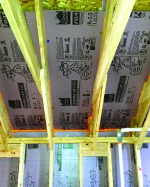 For a slight boost in R-value and to create a vent space that won’t be crushed by the pressure of dense-blown cellulose, the author’s company installs a custom insulation baffle in cathedral-roof rafter bays and scissors-truss bays.