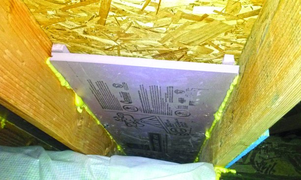 Thin strips of foam hold the R-5 baffle down from the sheathing.