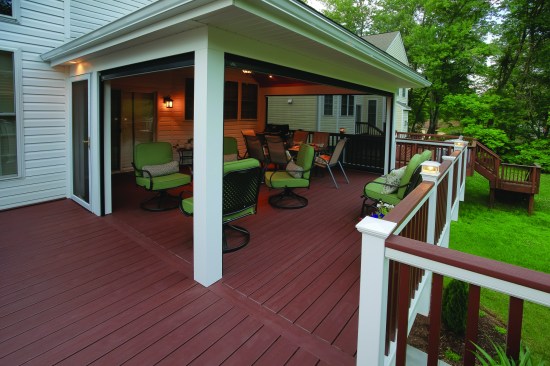 While fixed screen panels would create boundaries between the people using the porch and the adjacent deck, motorized retractable screens can quickly be used to remove those barriers when insects and weather conditions allow. A separate screen door is still required for regular access to the deck from the porch.