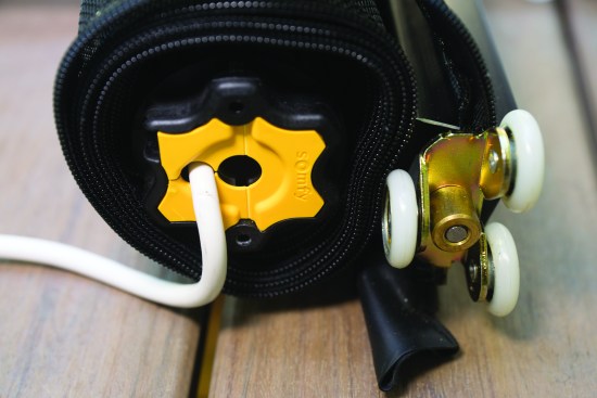 A Somfy tubular motor that can be inserted into either end of the rolled-up assembly powers the screen.