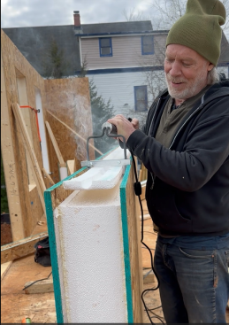 SIP modifications in the field are rare, but occasionally minor adjustments need to be made. Builder Matt Kulp uses a heat-activated SIP Groover to trim the EPS foam of a panel to prepare for installation at an outside corner at the Queen of Zero project.