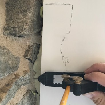 Using an AccuScribe Pro, the author draws the contours of the stone onto the workpiece. Be sure to hold the workpiece parallel to its intended position.
