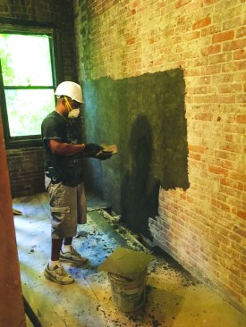 A lime mortar parge is the first layer to be applied to the brick masonry after rough repair is completed.