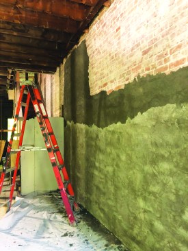 Next, the parge is coated with up to three coats of fluid-applied, vapor-open airtight sealing membrane.