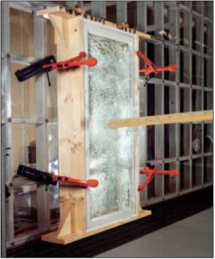An impact-resistant window can shatter and still pass the large missile test if the window remains largely intact through the 9,000 pressure cycles. The glass fragments tend to adhere to the plastic interlayer, which is considered intact if the size of any rips that develop during the test total less than 1/16 inch wide by 5 inches long.