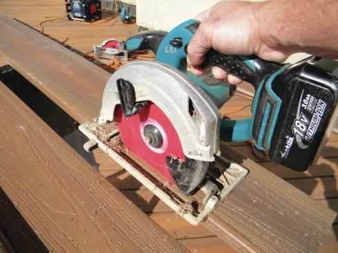 The trim can be cut on a table saw, but using a circular saw equipped with an edge guide is probably easier. The advantages to using a cordless circular saw are that it’s lightweight and it has enough power for this cut. A 20-foot length of square-edged Fiberon Horizon decking yields 40 linear feet of 3/8-inch-wide edge trim; the author sometimes uses a different width, depending on the brand of decking he’s working with.