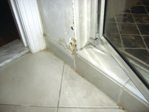 Cracks in tile and stone grout lines allow water through the finishes, even when those finishes aren’t submerged, which can cause damage such as that shown here.
