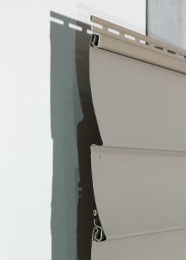 This siding just folds over the top edge of the hem.