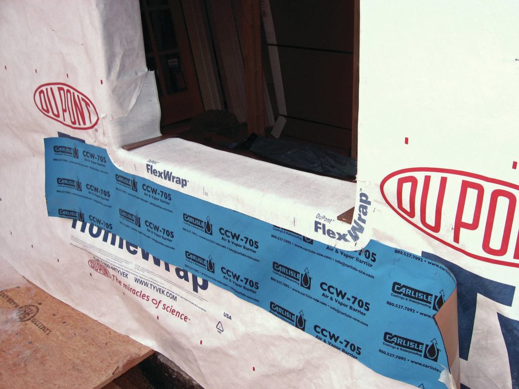 A key feature of a good window flashing is a drainable sill pan, which gathers the water leaking around a window unit and directs it to the outside. We find that a lot of masons, if left to their own devices, will let the sill pan drain into the air space behind the brick, leaving the through-wall flashing at the base of the wall to do all the work. However, we feel that best-practice should include a through-wall flashing right below each window that is integrated with the sill pan. Any water leaking from any window needs a clear path out of the wall as quickly as possible.