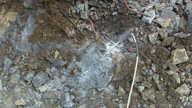 This is an example of rock in which an exploding charge has bisected the drill hole, revealing the pocket at its bottom that held the power cartridge.