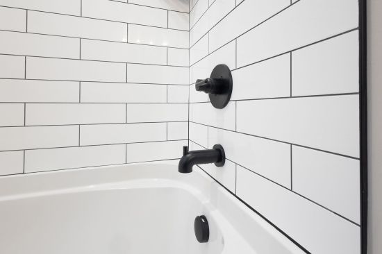 According to Six3Tile, their panels install faster than traditional tile and can be grouted immediately with standard unsanded grout.