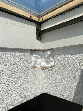 I cut inspection holes in the drywall in the existing skylight shafts so I could accurately measure the rough openings. Then I temporarily sealed the holes with spray foam.