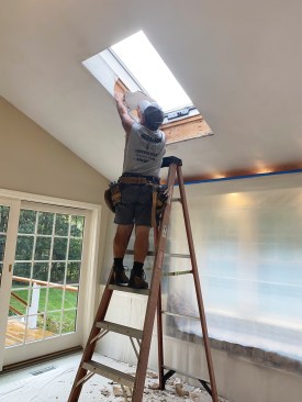 Before removing the drywall around the rough openings, I sealed off the wall and floor with plastic to catch the dust and debris.