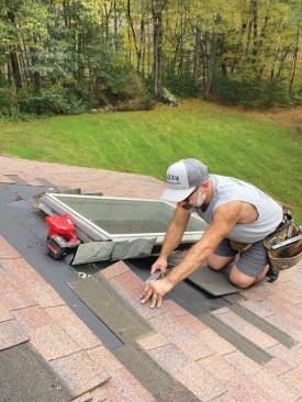I carefully removed the existing roof shingles around the skylights. I planned to reinstall them later.