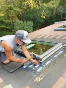 The Roto windows had been fastened to the roof with a few screws driven through angle brackets; the new, Velux skylights are fastened to the roof sheathing with 1 1/4‑inch roofing nails (included with the installation kit) driven through pre-punched holes in the units’ aluminum mounting flanges.