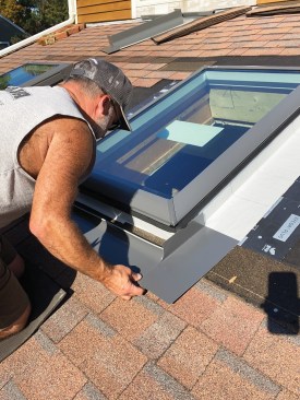 Then I installed the bottom section of the manufacturer’s metal curb-flashing kit, which is designed to slip underneath a rubber flange that wraps around the curb of the unit.