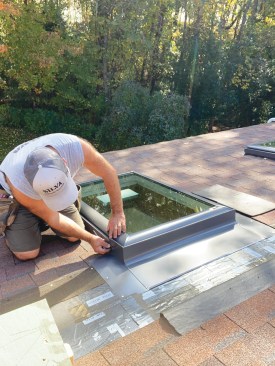Next, the metal head flashing was fastened to the lower piece with clips. A couple of roofing nails on either side of the flashing fastened it to the roof deck and would later be covered with shingles.