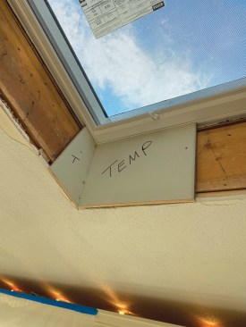 I prefer to use 1/2-inch medium density overlay (or MDO) panels instead of drywall to cover the rough framing of a skylight shaft, partly because MDO is tougher and more moisture-resistant, but mainly because this allows me to prefabricate the shaft and install it as a single unit. I start by making a trim template to find the angle and check the fit of the MDO within the slots of the skylight jambs.