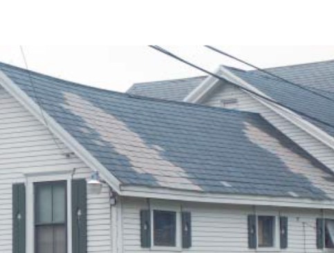 This repair with mismatched slates stands out like a sore thumb. If matching shingles were not available; the roofer could have repositioned existing slates while installing the new ones in a decorative pattern or band.