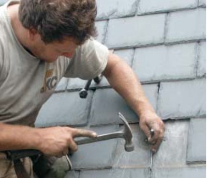 Sometimes the installer needs to punch and grind a pilot hole for the hook into the crack between the two slates in the course below.