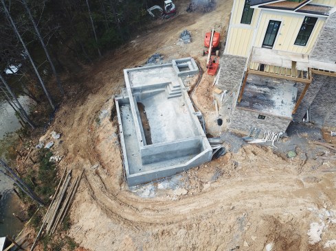 Early in the project, workers formed and poured the infinity edge pool.