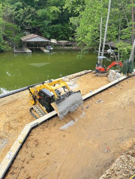After the pool was in place, workers began the process of building the retaining walls and backfilling them with gravel and soil to create the two lower terraced levels.