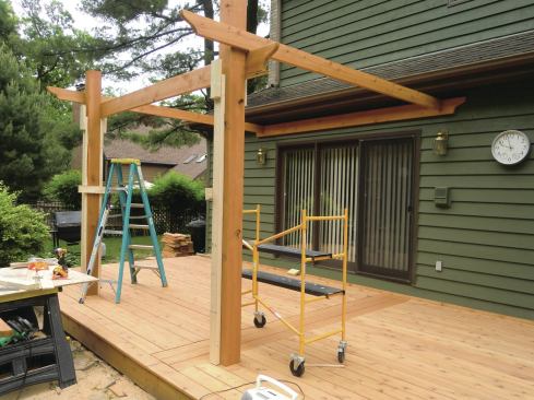 Braces and cleats made from 2x4s act as extra hands to hold the beams in place while they are being leveled and fastened.
