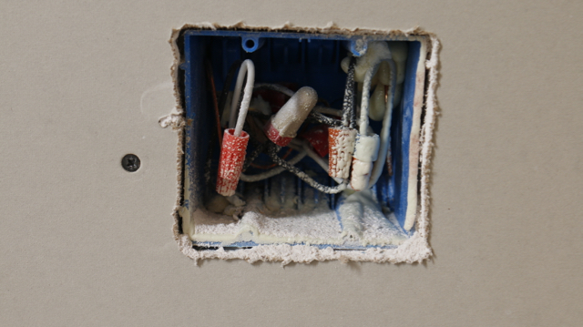 Notice the air gaps around the edge of the drywall? This hole must be filled with Acoustic Sealant.