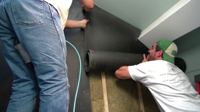 The Sound Barrier membrane must be carefully fitted around the ceiling beams.