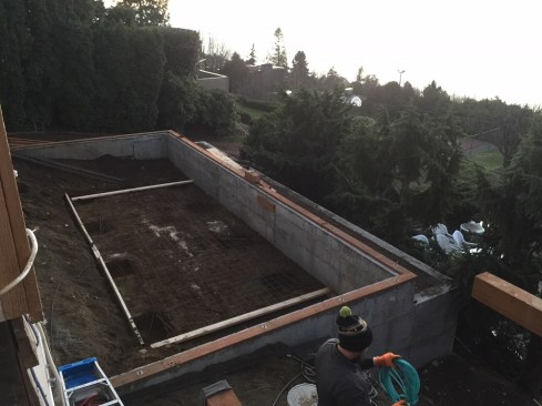 A reinforced slab was needed to support the large spa, which weighs over 21,000 pounds when full. Note the excavations for additional footings to support the piers that will also bear on the slab.