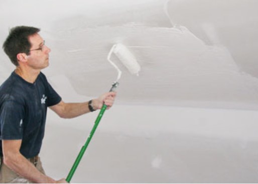 He applies it to the drywall with a 1/2-inch nap paint roller
