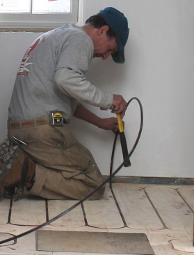 Low-temperature, above-floor radiant distribution proves more responsive than radiant slabs. This example uses 5/16-inch PEX tubing set in channeled panels installed directly over 3/4-inch subfloor.