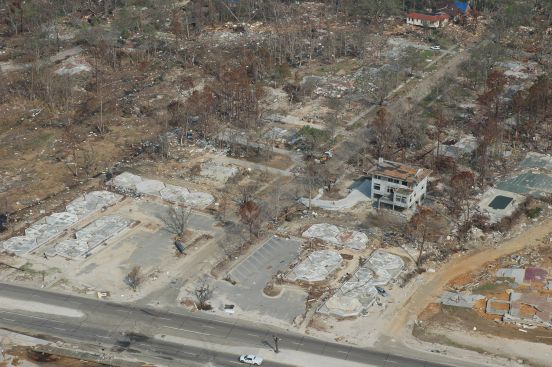 An elevated concrete home under construction is the only building left standing among "slabbed" conventional homes in this aerial photo taken after Hurricane Katrina, in Pass Christian, Miss.