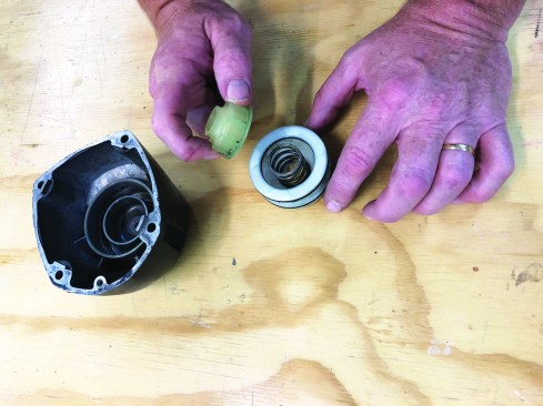 Place the compression spring and piston stop inside the piston head valve