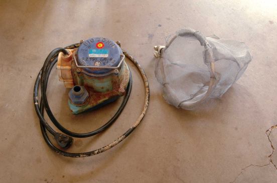 A small, reliable sump pump with an internal pressure-activated switch can move more than 2,500 gallons of water per hour. The homemade filter was fashioned from window screen attached to a loop of Romex.