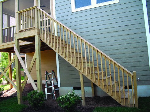 Stair guard posts should be located so that the span between posts (as measured horizontally) is no more than 6 feet. This is a photo of a new deck that has passed inspection.