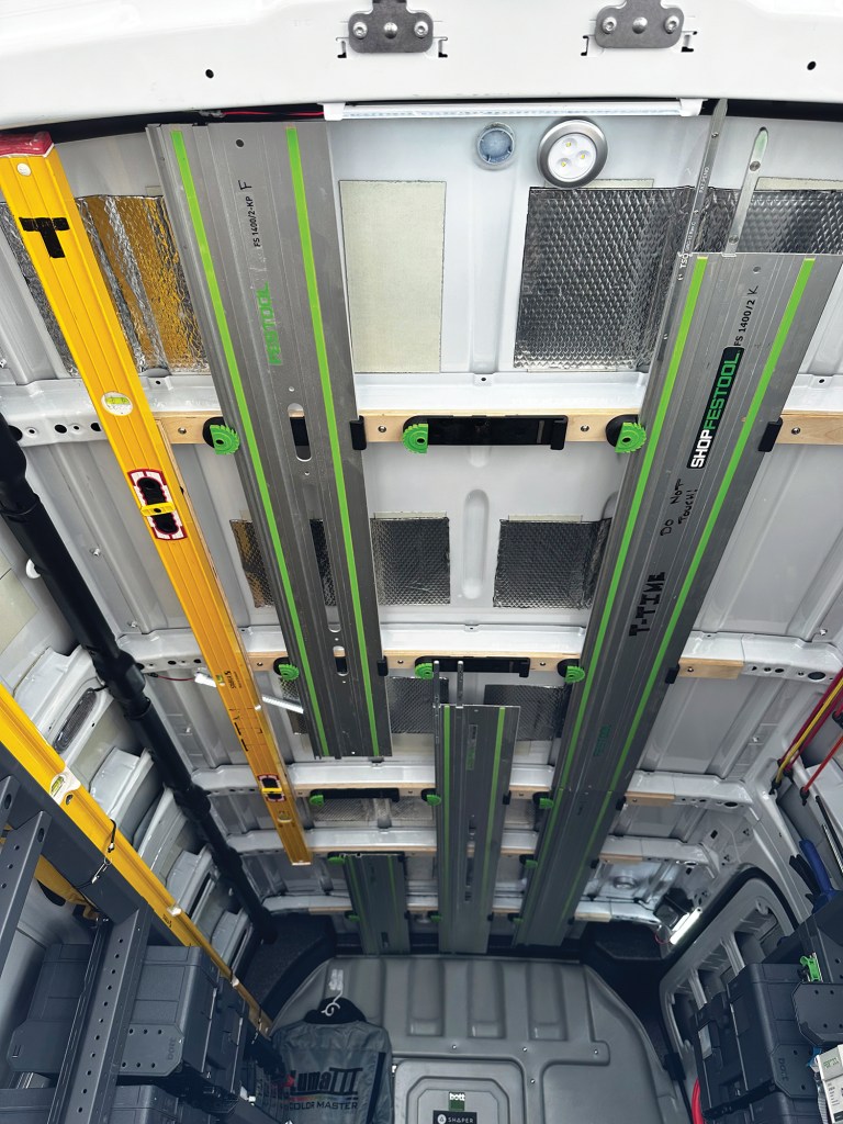 The author mounted several sets of StealthMount's guide-rail holders on the ceiling of his work van to store his set of guide rails.