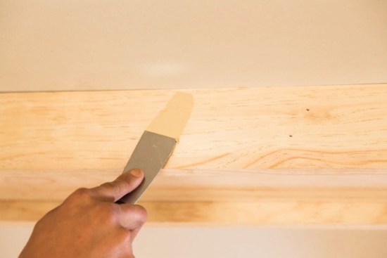 6 – Clad the BeamsFinishing the beams is the easiest part of the job. Start by nailing the pine boards you chose in Step 1 to the bottom of the nailers. Clad the perpendicular nailers first, so that the joints on the finish boards and the nailers don't align. For an interesting 3D look, rip the trim for the sides to a width that creates a 3/4 in. reveal. If the design calls for locating light fixtures on the beam, use a hole saw to cut the necessary holes. The inside edges can be finished with crown molding or not, depending on the beam depth and the customer's wishes.