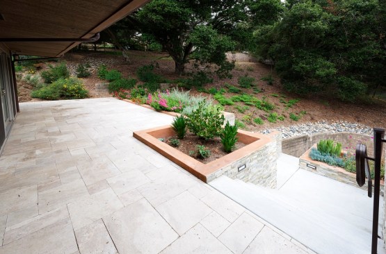 The 1 1/4-inch-thick travertine pavers were set in a Versailles pattern. Commonly used for indoor tile installations, this pattern does not have continuous grout lines.