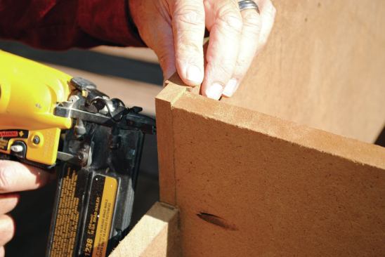 Because the cabinets would be outside and exposed to the weather, I sloped the bottoms 1/8 inch downward from the back to the front; that way, if any water got in, it would flow toward the front. I also cut the bottom pieces of the boxes about 1/8 inch short of the cabinet front so water would have a way to drain out.