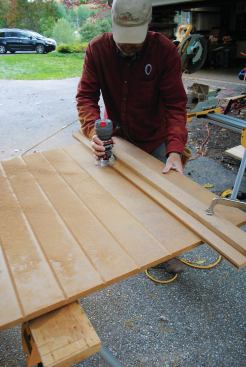 I wanted to dress up the back side of the cabinets, too. My solution was to rout vertical V-grooves into ¾-inch-thick Extira panels, using a straightedge and a trim router. To support the paneling at the outside corners, I added blocking. The crew that framed the deck did a great job keeping the posts plumb, so it didn't take much work to fit each panel between them.