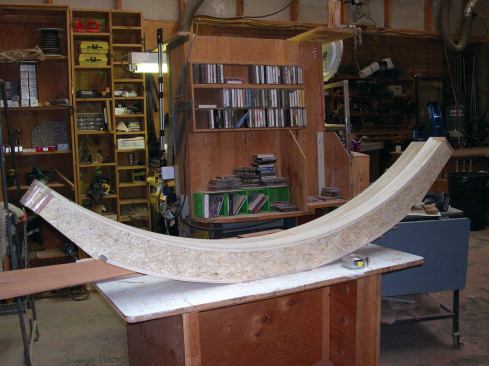 I coated the layers with waterproof West System 105 epoxy (the only adhesive used for this project), then stapled them together using 7/16-inch by 1 1/2-inch galvanized staples on 4-inch centers. Next, I glued a double layer of 1/4-inch poplar to the inner and outer curved surfaces; this conserved the more costly sapele, which would form only the outer 1/4-inch layer on the curves.