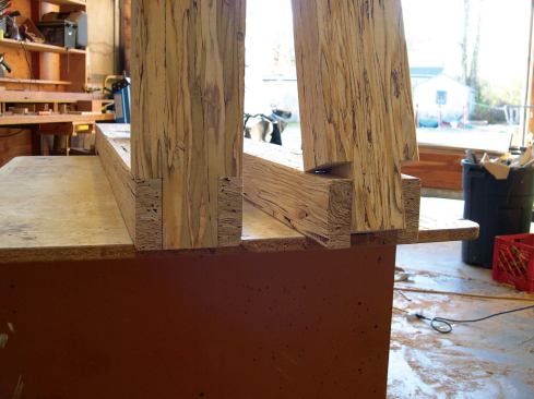 On the opposite ends, I used a band saw to cut forks for a saddle joint of the horizontal members, and to cut reciprocal tongues on the vertical.